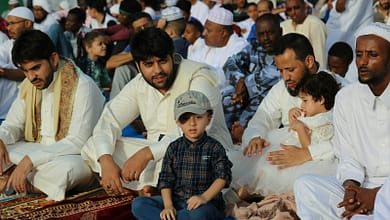 crowd sitting on floor during daytime
