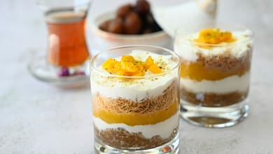 a couple of glasses filled with food on top of a table