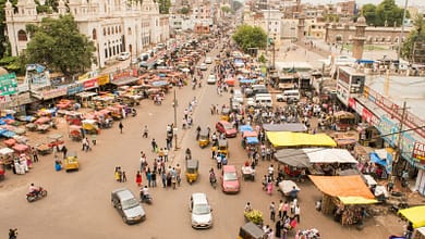 aerial photography of people and vehicles near mosque at daytime