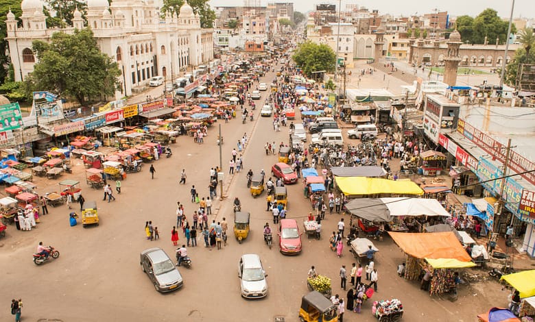 aerial photography of people and vehicles near mosque at daytime
